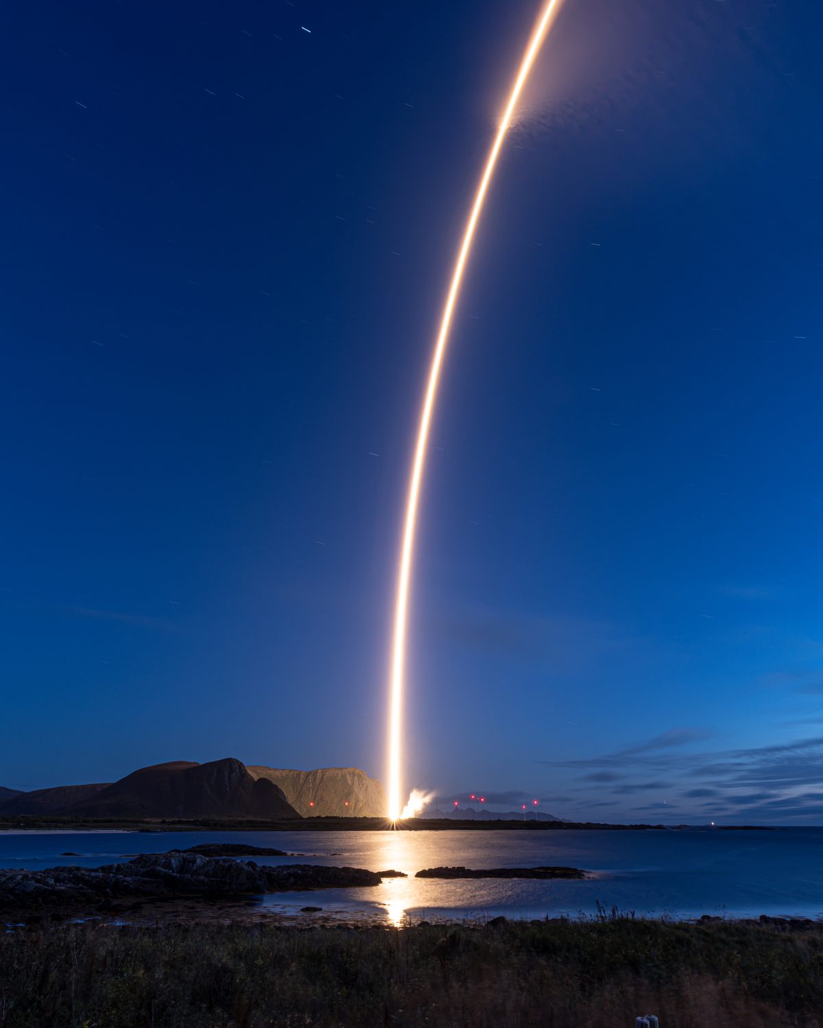 Long-exposure launch arc over the Norwegian coast
